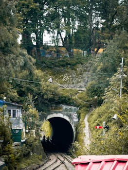 Picturesque view of a railway tunnel surrounded by greenery in Solan, Himachal Pradesh, India.